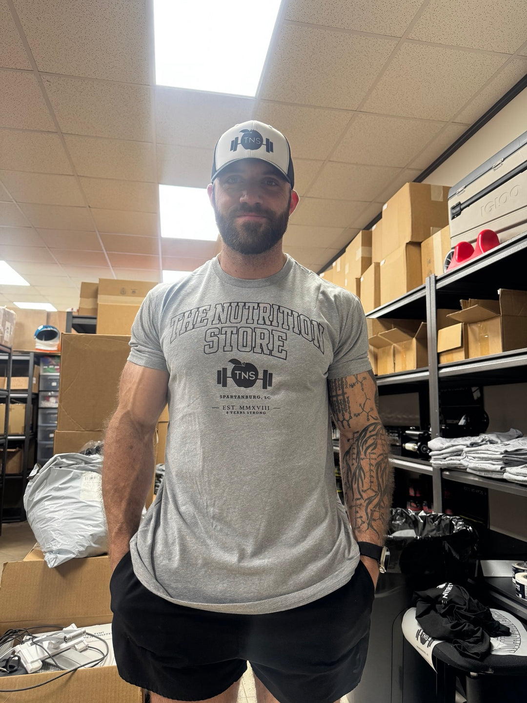 Heather gray collegiate TNS shirt modeled at The Nutrition Store